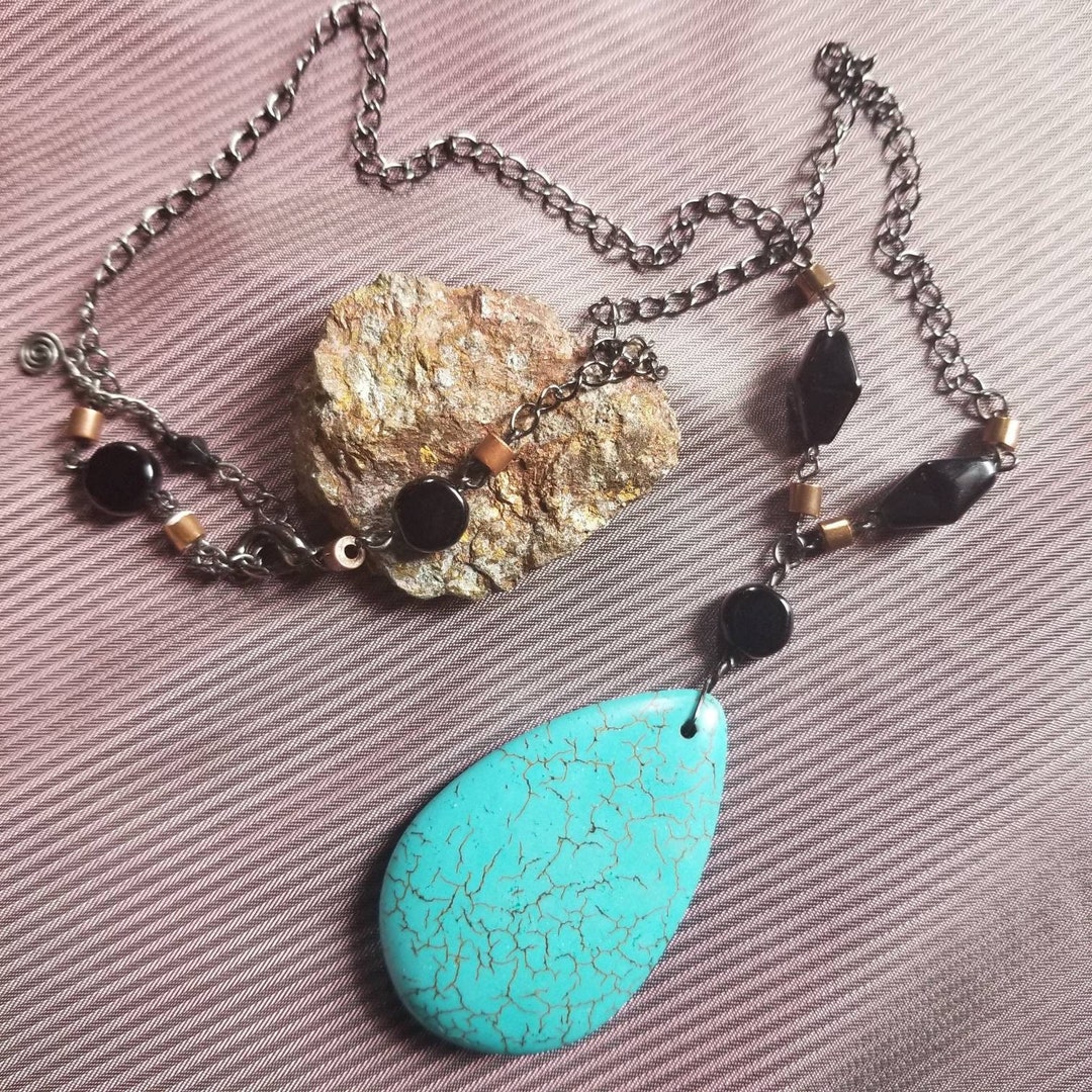 Blue howlite teardrop pendant with black beads. Black and copper beads