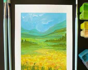 May include: An original landscape painting featuring a field of yellow flowers, green hills, and a blue sky. The artwork is on white paper, with three paintbrushes and paint containers in the background. The painting is a vibrant display of nature.