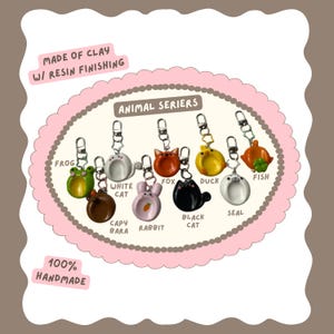 May include: A collection of handmade clay keychains with resin finishing, featuring various animal designs such as a frog, cat, fox, duck, and fish. The keychains are attached to silver-colored keyrings. The text "ANIMAL SERIERS" is displayed.