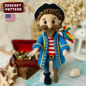 May include: A handmade crochet pirate doll, featuring a blue coat with yellow detailing, a red and white striped shirt, and a black hat. A colourful parrot perches on the shoulder. The text "CROCHET PATTERN" is visible.