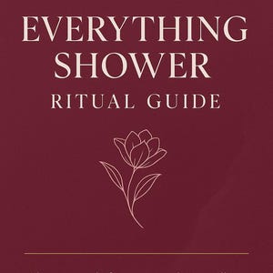 May include: A maroon book cover with the title "EVERYTHING SHOWER RITUAL GUIDE" in white text. The cover also includes the text "RADIANT REINVENTION" and a line drawing of a flower. The bottom of the cover reads "Glow-up tools for women who've still got it — and get sexier with age."