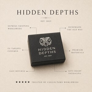 May include: A square black box with the white text HIDDEN DEPTHS and a logo featuring two faces. The box is surrounded by text labels including EST. 2025, HANDMADE THE OLD WAY, PREMIUM MATERIALS, GIFT READY PACKAGING, EASY RETURNS, US TARIFFS COVERED, and EXPRESS SHIPPING WORLDWIDE.
