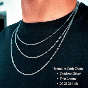 May include: Three oxidized silver curb chains of varying lengths are displayed against a black background. The chains are thin, measuring 2.4mm, and range from 20 to 24 inches in length. The text "Premium Curb Chain" is visible.