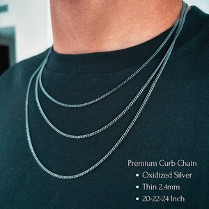 May include: Three layered oxidized silver curb chains with a thin 2.4mm width. The text on the image reads: Premium Curb Chain, Oxidized Silver, Thin 2.4mm, 20-22-24 Inch. The chains are displayed against a plain black fabric background.