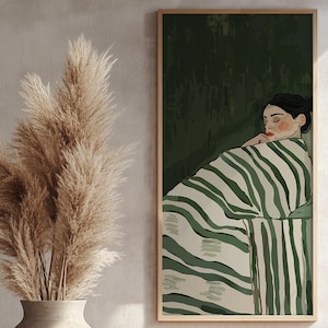 May include: A framed illustration of a woman sleeping under a striped blanket. The background is a dark green color.