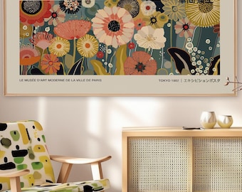 May include: A framed art print featuring a floral design by Yayoi Kusama. The artwork showcases a variety of colorful flowers in shades of red, orange, yellow, and white against a dark teal background. Text includes the artist's name and exhibition details.