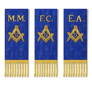 May include: Three blue Masonic sashes with gold fringe. Each sash features gold embroidered symbols and lettering: "M.M.", "F.C.", and "E.A.". The sashes have a repeating pattern in the background.