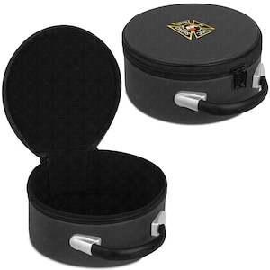 May include: Black circular travel case with a zip closure and a handle. The case features a repeating pattern and a gold and red emblem on the top. The interior is black.