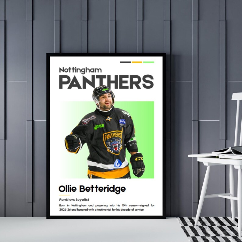 May include: A framed poster featuring Nottingham Panthers hockey player Ollie Betteridge. The poster has a black frame and a white background with the team's name in large letters. Betteridge is wearing a black and gold jersey.