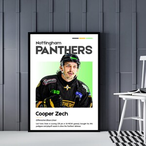 May include: A framed poster featuring Cooper Zech of the Nottingham Panthers hockey team. The poster has a black frame and includes the team name, player's name, and a brief description. The player is wearing a black and yellow jersey and a helmet.