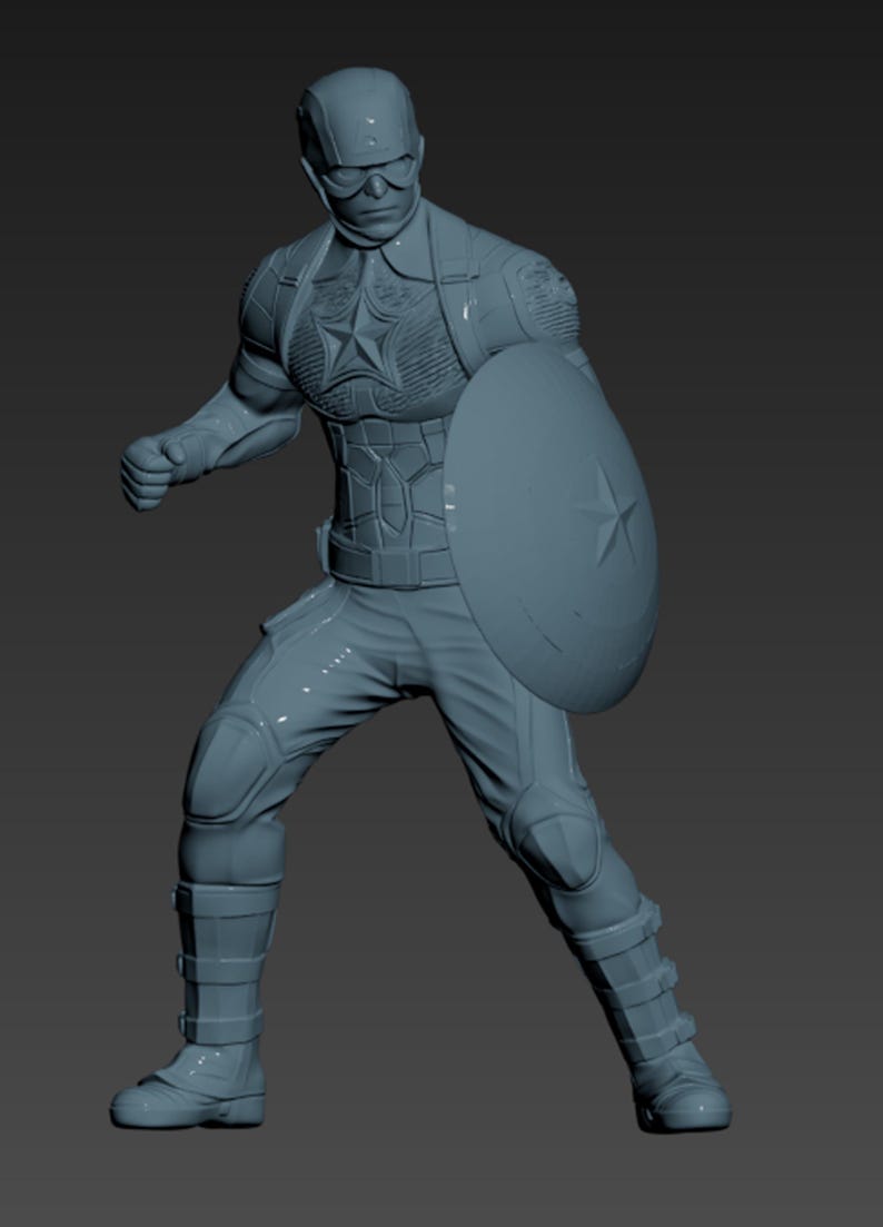 May include: A gray figurine of Captain America in a dynamic pose, holding his iconic shield. The figure is detailed with a helmet, goggles, and a star emblem on the chest. The character is wearing a suit with protective gear.