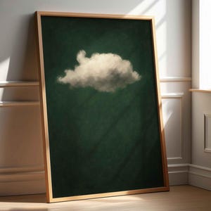 May include: A framed print of a single white cloud against a dark green background.