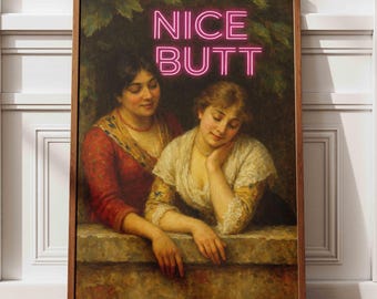 May include: Framed art print featuring a classical painting of two women. The artwork is in a wooden frame and has the words "NICE BUTT" in pink neon-style lettering across the top. The women are dressed in period clothing.