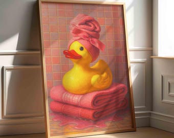 May include: A framed print featuring a yellow rubber duck wearing a pink towel turban, perched atop a stack of pink towels. The background shows a pink tiled wall, with a wooden frame and a light-colored floor.
