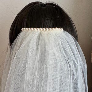 Add Swarovski pearls, flowers, or bow tie to your veil - veil sold separately