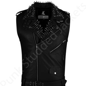 May include: Black leather vest featuring silver spike studs around the collar. The vest includes a zip closure, a belt, and a small pocket. The brand name "ARVANE LEATHER" is displayed on a small label.