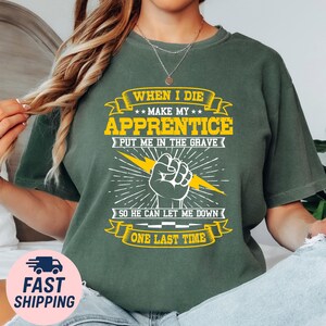 May include: Dark green t-shirt with the text "WHEN I DIE MAKE MY APPRENTICE PUT ME IN THE GRAVE SO HE CAN LET ME DOWN ONE LAST TIME". The design includes a fist with a lightning bolt and star accents.