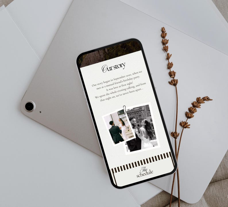 May include: A smartphone displays a wedding story with the title "Our Story" and two black and white photos. The phone rests on a silver tablet and is accompanied by dried lavender sprigs. The bottom of the phone reads "The schedule."