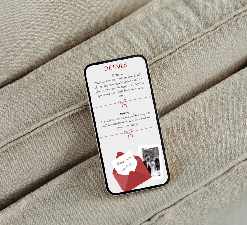 May include: A smartphone displaying wedding details against a neutral fabric backdrop. The screen shows text about children and parking, along with a red envelope graphic and a photo. The phone's screen is white with black text.
