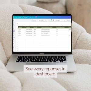 May include: A silver MacBook Pro laptop displaying a spreadsheet with data, resting on a cream-colored upholstered surface. The screen shows a table with columns and rows of data. Text at the bottom reads: "See every reponses in dashboard."