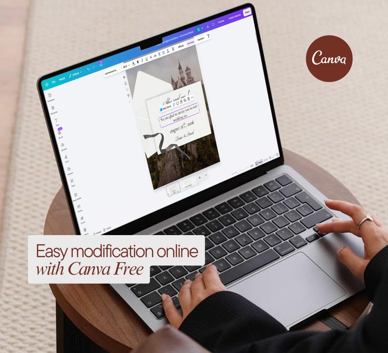 May include: A laptop displaying a wedding invitation design with a castle image. The screen shows text and design elements. The text "Easy modification online with Canva Free" is displayed on the bottom of the screen. A person's hands are on the keyboard.