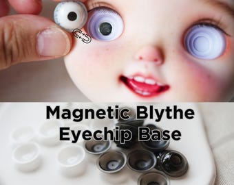 May include: A set of Magnetic Blythe Eyechip Base components in white and black colors. The image shows a doll face with a magnetic eye mechanism and a collection of small, bowl-shaped plastic bases for customizing doll eyes with magnets.