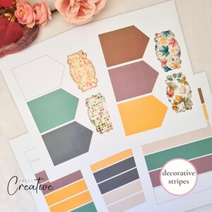 May include: A collection of printed paper sheets featuring colorful designs. The sheets include geometric shapes in shades of brown, purple, and yellow, along with decorative leaf patterns and the text "decorative stripes". The "Angel Creative" logo is visible.