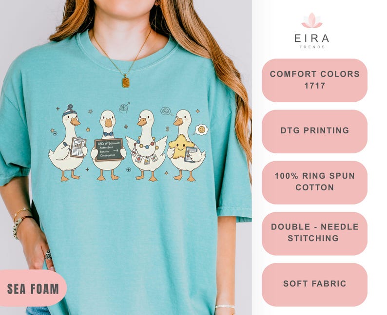 May include: Sea foam green t-shirt featuring a cartoon design of four ducks, each holding different items. The ducks are wearing hats, bow ties, and necklaces. The text "EIRA TRENDS" is at the top.