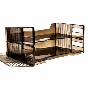 May include: A two-tiered document tray made of translucent, smoky brown plastic. The unit features a ribbed, vertical texture on the side panels and an open-front design for easy access to stacked papers, providing a clear view of the contents.
