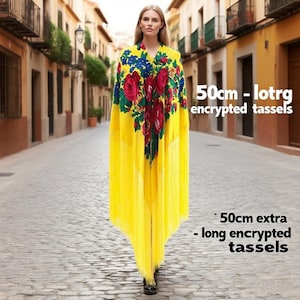 May include: A woman wearing a yellow shawl with a floral design of red roses and blue flowers. The shawl has long, yellow fringe and the text "50cm - lotrg encrypted tassels" and "50cm extra - long encrypted tassels".