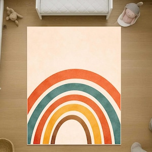 May include: A rectangular area rug featuring a centered rainbow graphic with concentric arches in shades of burnt orange, teal, yellow, and brown against a solid cream-colored background. The design is symmetrical and covers the rug surface.