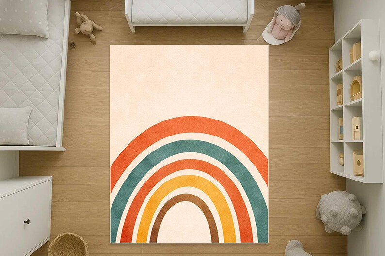 May include: A rectangular area rug featuring a centered rainbow graphic with concentric arches in shades of burnt orange, teal, yellow, and brown against a solid cream-colored background. The design is symmetrical and covers the rug surface.