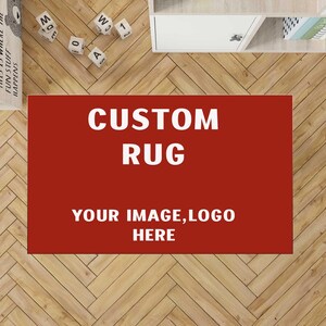 May include: A rectangular custom rug with a solid dark red background. The text CUSTOM RUG is printed in large white capital letters at the top, followed by the text YOUR IMAGE, LOGO HERE in smaller white capital letters centered below.