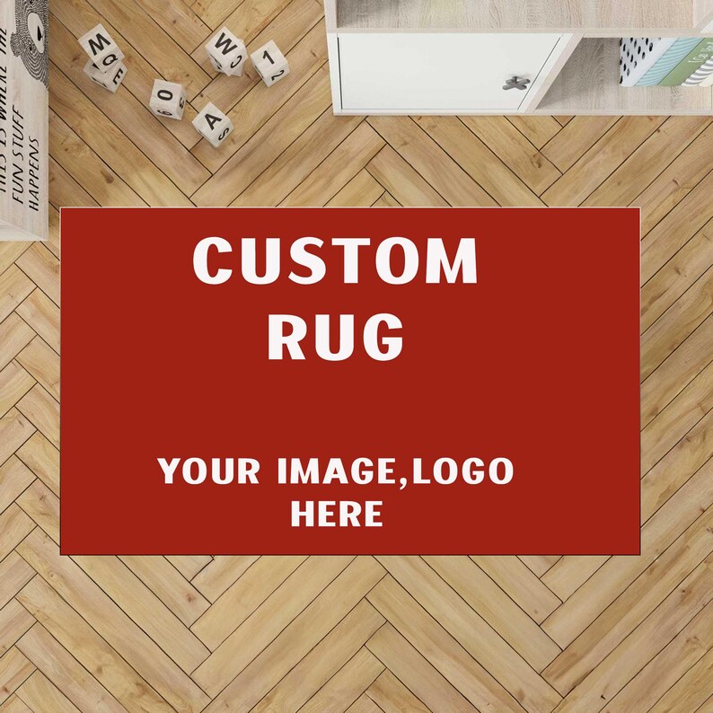 May include: A rectangular custom rug with a solid dark red background. The text CUSTOM RUG is printed in large white capital letters at the top, followed by the text YOUR IMAGE, LOGO HERE in smaller white capital letters centered below.