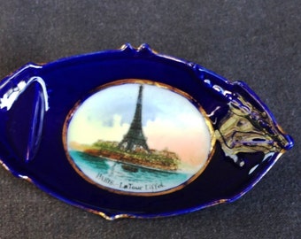 Vintage cobalt blue Eiffel Tower souvenir ashtray from Paris France. Retro French landmark ceramic memorabilia. Traveler's home decor gift.