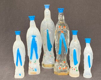 The French holy water Virgin bottles instant collection of six. Kitsch souvenir from a religious pilgrimage to Lourdes in France.