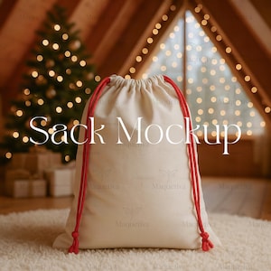 May include: A cream-colored drawstring sack with red cords, labeled "Sack Mockup" in white text. The sack is on a white rug, with a Christmas tree and fairy lights in the background.