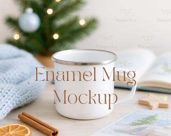 May include: A white enamel mug with a silver rim, the text "Enamel Mug Mockup" is printed on the front. The mug is on a light wood surface with cinnamon sticks, a dried orange slice, and a small Christmas tree in the background.
