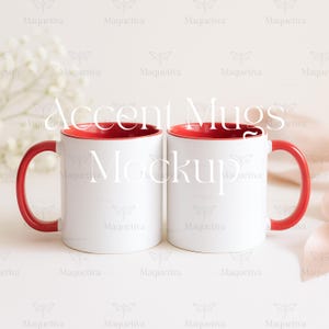 May include: Two white ceramic mugs with red interiors and handles are displayed. The mugs are side-by-side, showcasing a clean, minimalist design. The text "Accent Mugs Mockup" is overlaid on the image. The background is a soft, neutral tone, with subtle floral and ribbon accents.