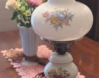 Vintage Hurricane-tafellamp van melkglas met bloemen en sierlijke metalen voet