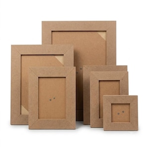 May include: A collection of five rectangular picture frames made of light brown composite wood material. The frames are arranged in a tiered formation, featuring varying sizes with wide, flat borders and visible metal fasteners on the back panels.