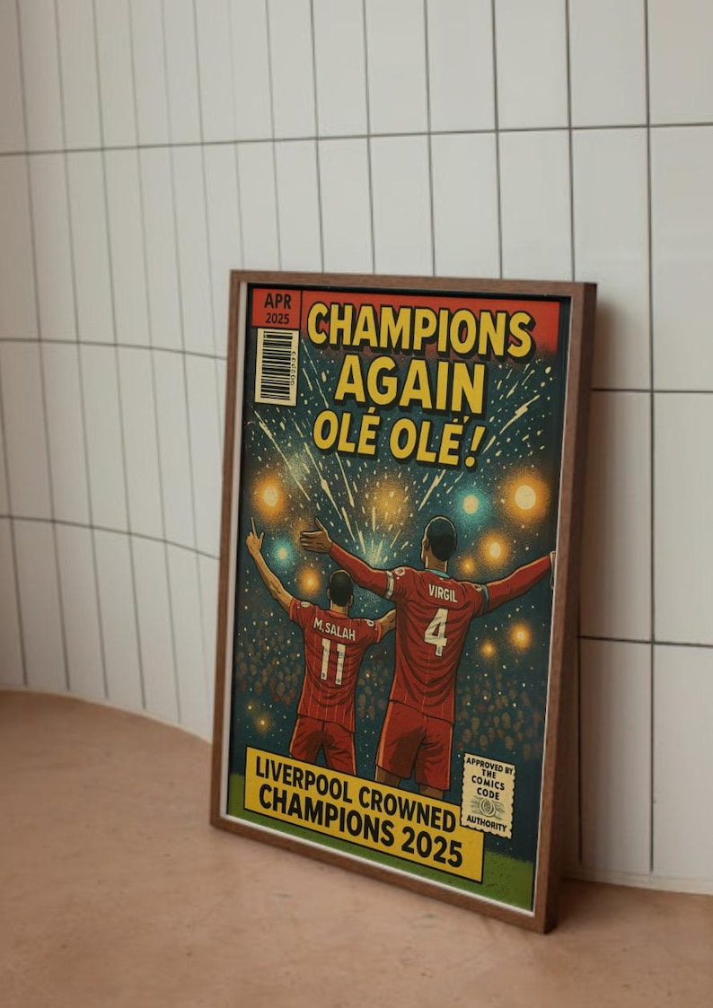 May include: A comic book cover illustration featuring two soccer players celebrating a victory. The cover is titled "Champions Again Ole Ole!" and features the text "Liverpool Crowned Champions 2025".