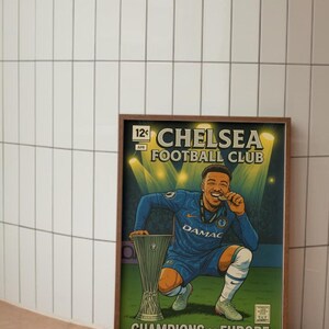 May include: A framed print in a comic book style, depicting a Chelsea Football Club player celebrating a win. The player wears a blue kit, holding a medal and the trophy. The print includes the text "CHELSEA FOOTBALL CLUB" and "CHAMPIONS OF EUROPE".