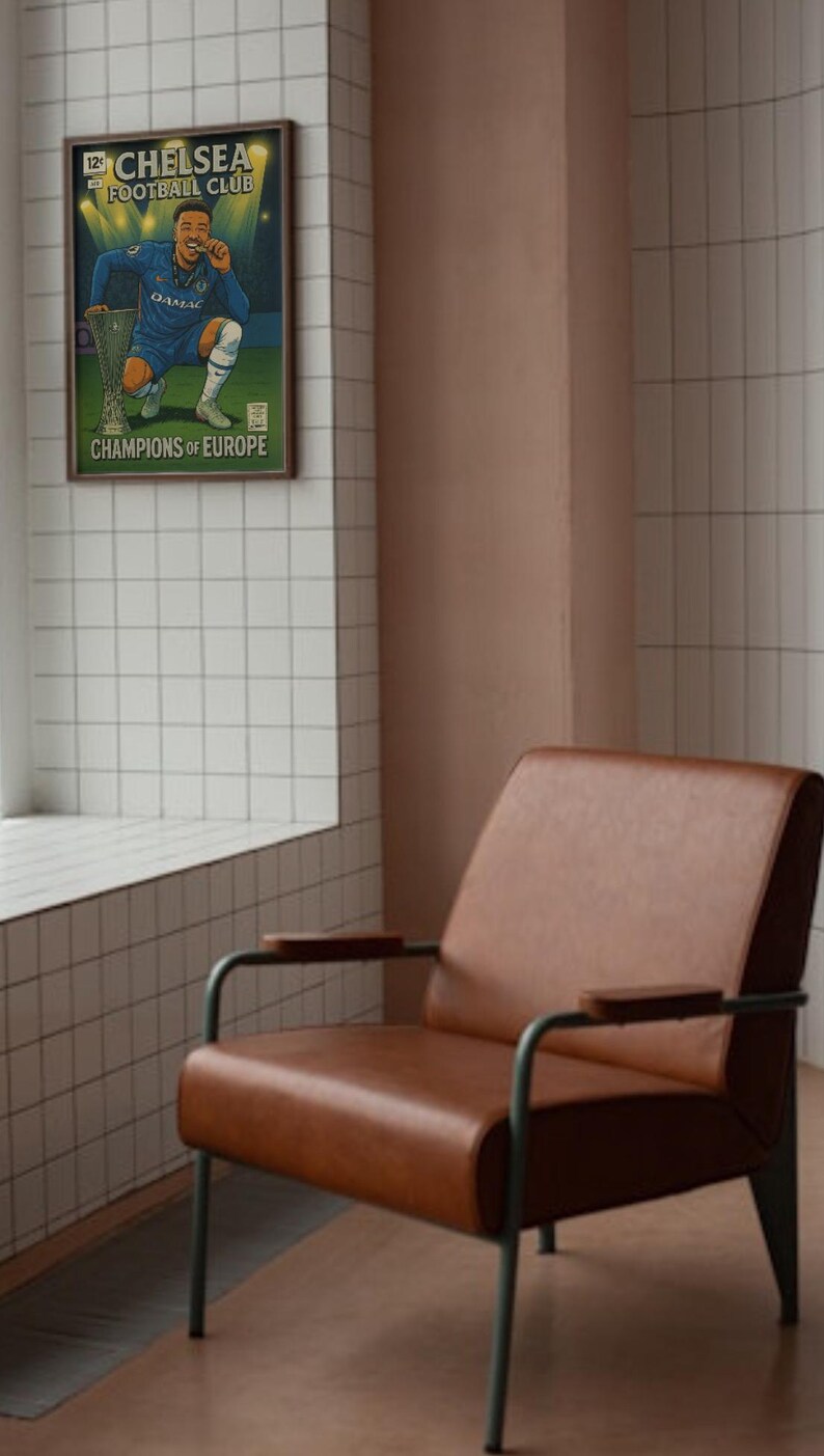 May include: A framed poster of a Chelsea Football Club player with a trophy, text reads "Champions of Europe." The poster is above a brown leather armchair with a metal frame. The room has white tiles and a pink wall.