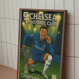May include: A framed print in a comic book style, depicting a Chelsea Football Club player celebrating a win. The player is in a blue kit, holding a trophy and a medal. The print includes the text "CHELSEA FOOTBALL CLUB" and "CHAMPIONS OF EUROPE."