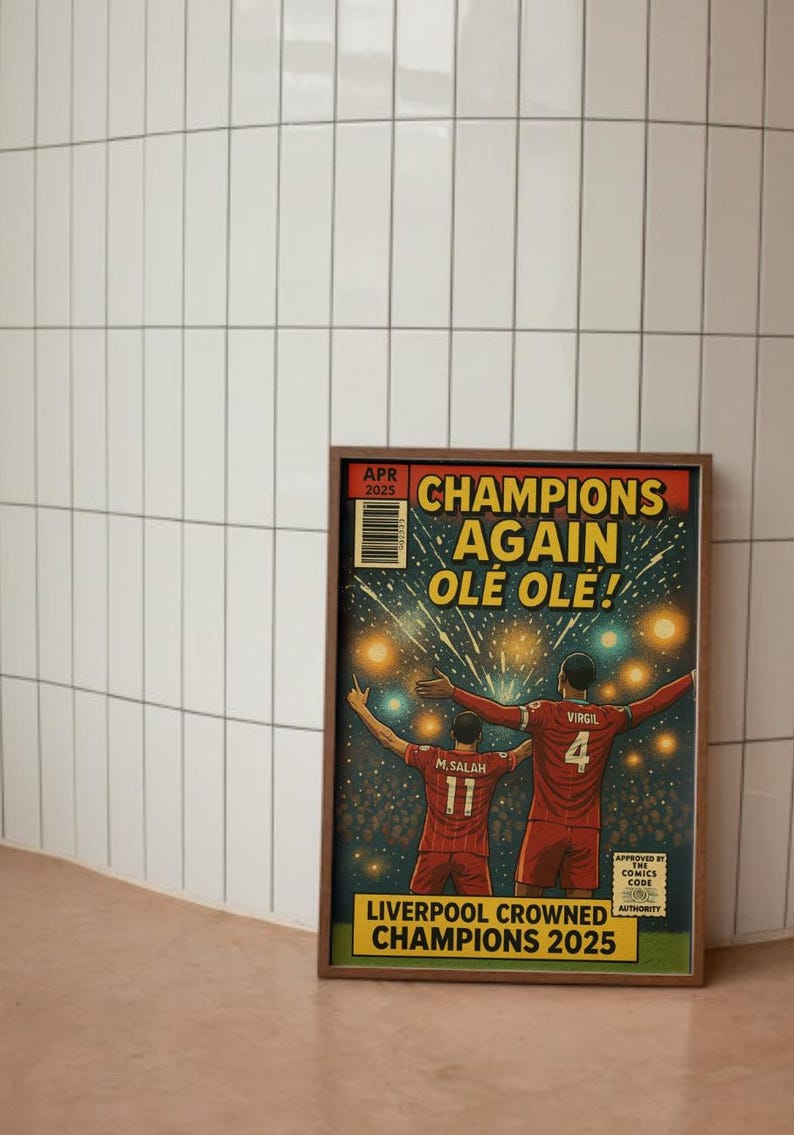 May include: A comic book cover featuring two soccer players celebrating a victory. The cover is titled "Champions Again Ole Ole!" and features the text "Liverpool Crowned Champions 2025".