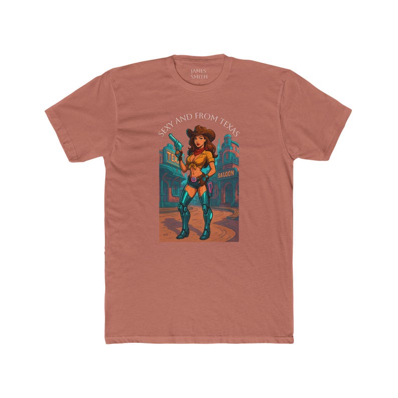 May include: A terracotta-colored t-shirt featuring a graphic of a cowgirl holding a gun in front of a saloon. The text "Sexy and From Texas" is above the graphic. The shirt is made of a soft, comfortable material.