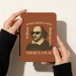 May include: A brown case featuring a portrait of William Shakespeare wearing sunglasses. The text reads "WHERE THERE'S A WILL, THERE'S A PLAY" with "William" and "Shakespeare" on the sides. The case is held by hands.