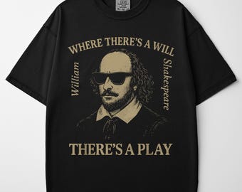 May include: Black t-shirt featuring a sepia-toned illustration of William Shakespeare wearing sunglasses. The text reads "WHERE THERE'S A WILL, THERE'S A PLAY" in a circular design around the portrait. The shirt is a Comfort Colors XL.
