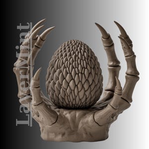 May include: A brown, textured egg-shaped object cradled by a skeletal hand with sharp claws. The egg has a scale-like pattern. The background is a gradient of gray and white. The text "LayerMint" is visible on the left side.